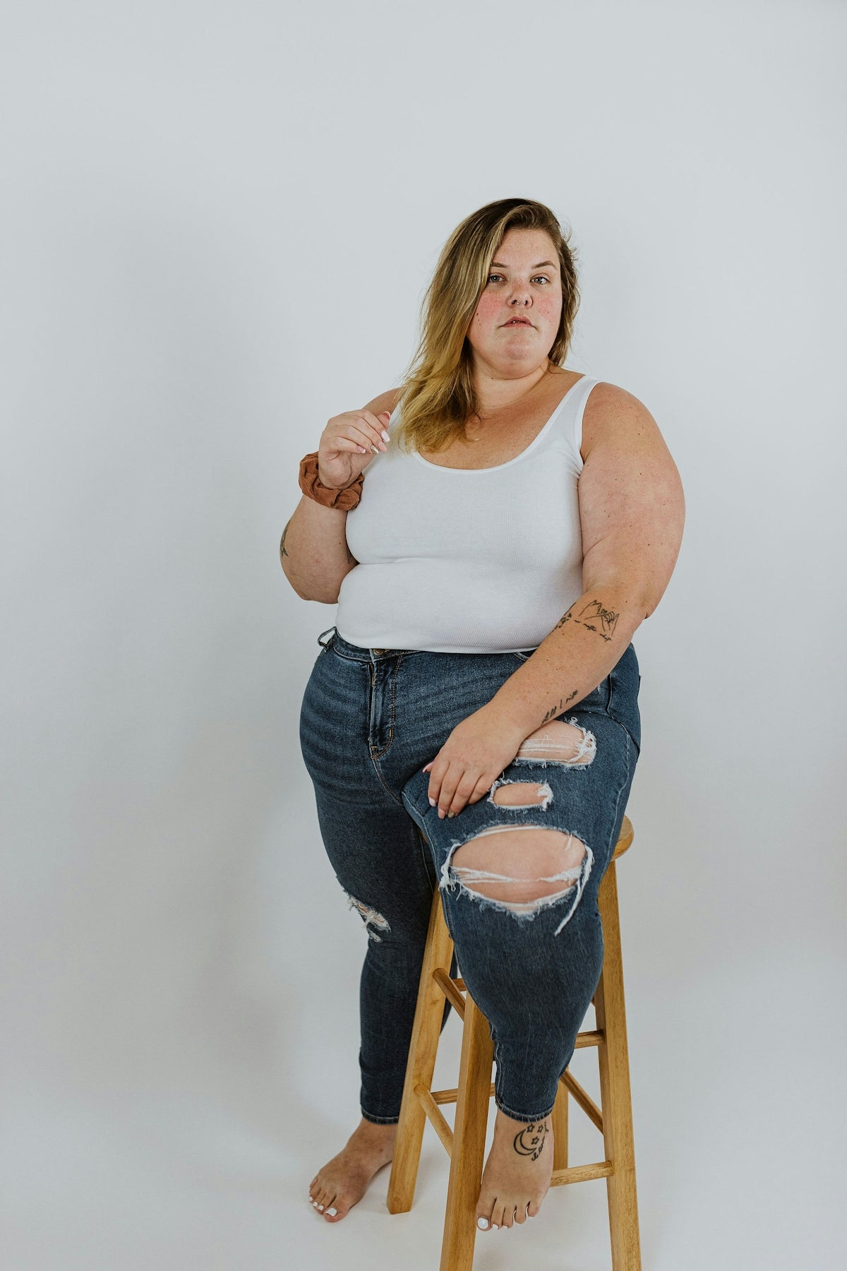 a woman sitting on a stool