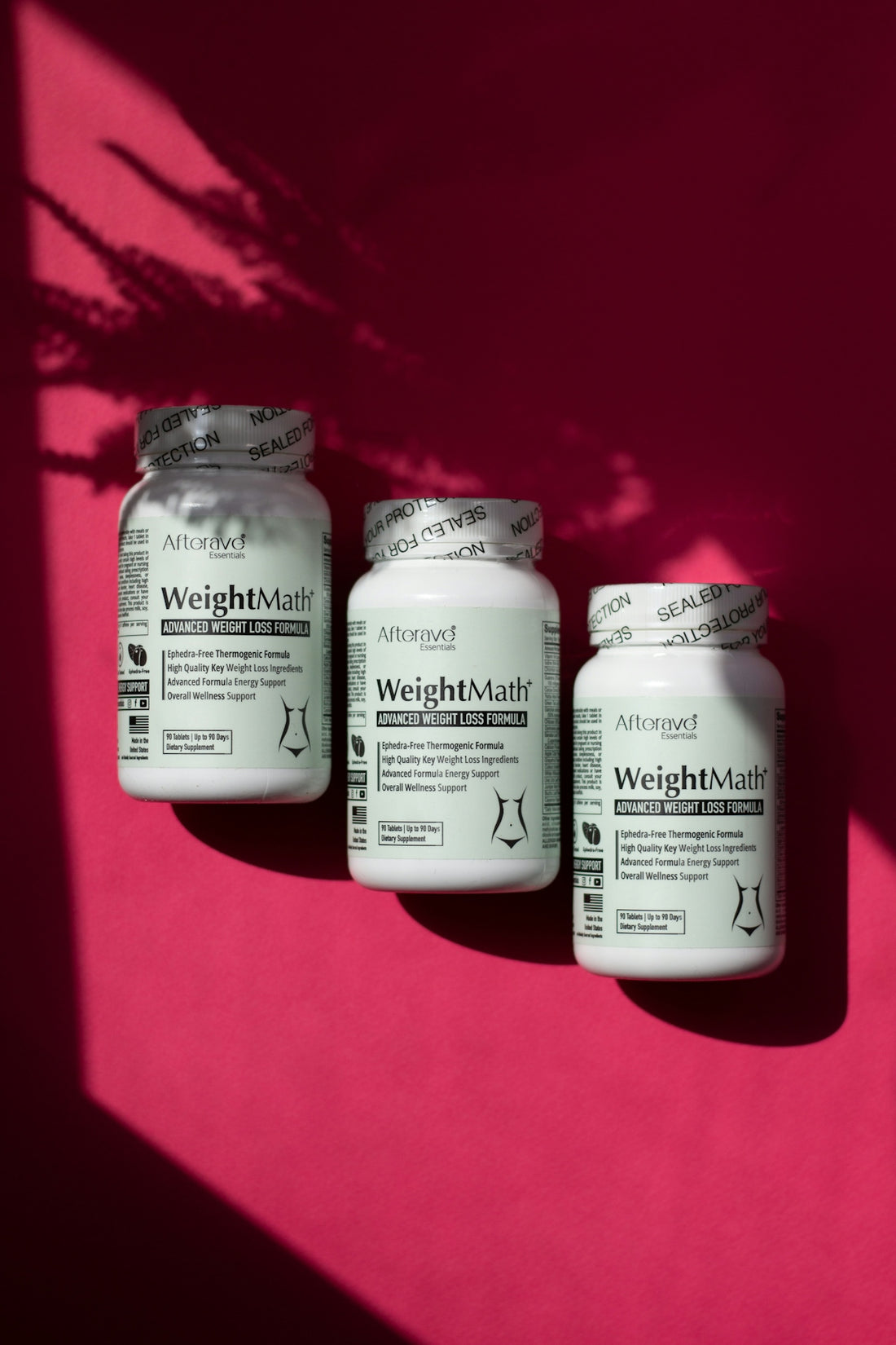 Three jars of weight loss pills on a pink background