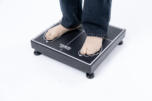 Person standing on a black scale