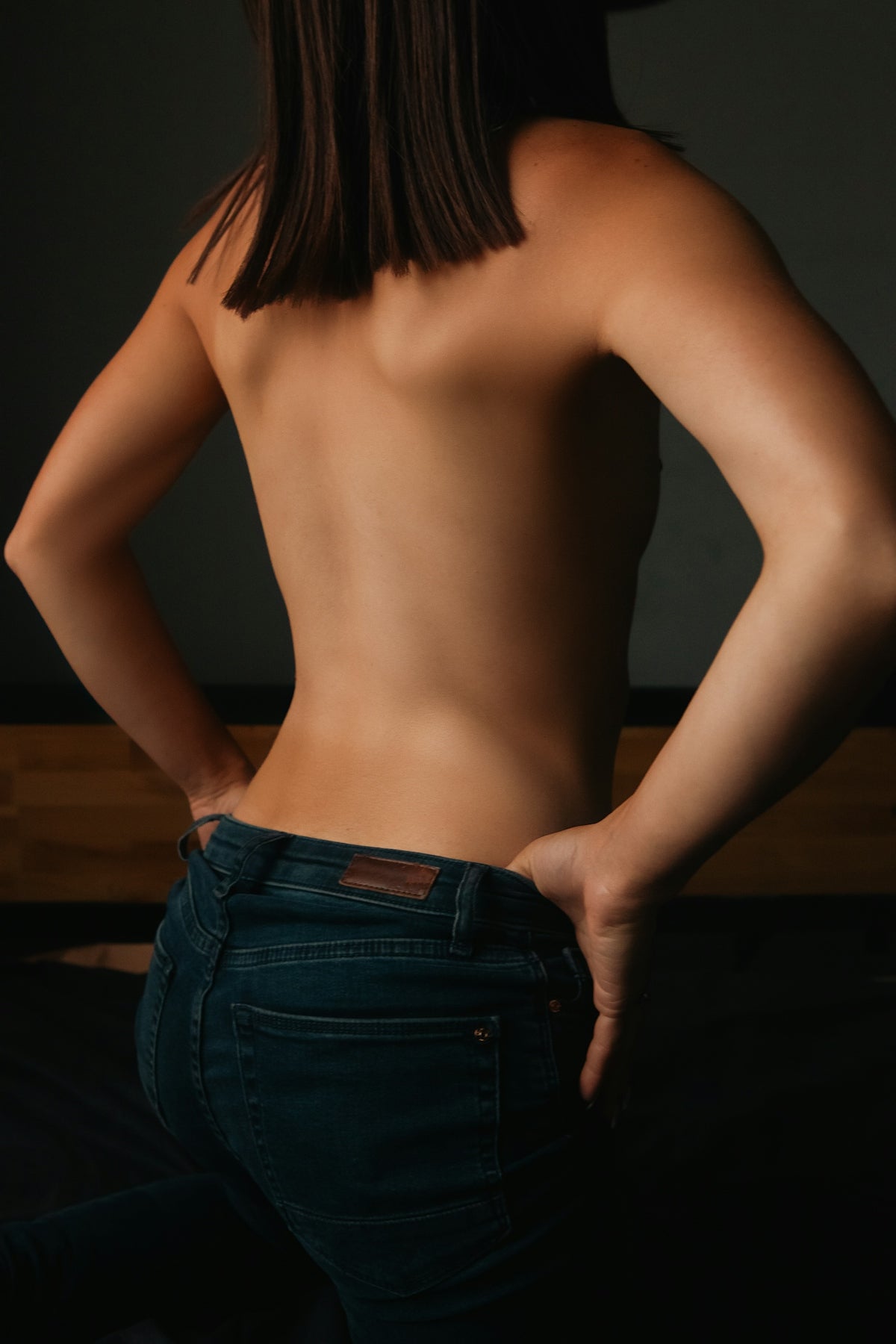 Woman in jeans with hands on hips